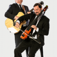 Mike and Greg happily playing music on the guitar and a violin, the violist is on a stool