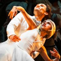 Male dancer with female dancer in front of him wearing white in a smooth pose