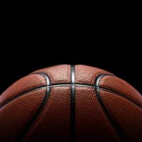 Half Basketball against black back ground