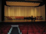 Audience seating on theater stage with a grand piano from the main floor