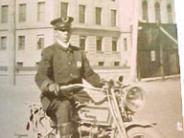 Circa 1910 Officer on an early Harley Davidson motorcycle