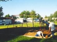 Repairing playground border around a swing set