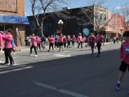 Runners mill about on the street as they wait for the race to begin.