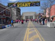 Runners mill about near the start line as they wait for the race to begin.
