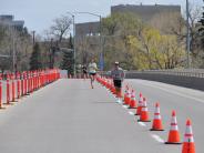 The front runners in the Ice Breaker Road race continue down the race path, which is lined with orange cones