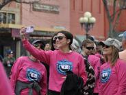 A runner taking a selfie with several other runners before the race 