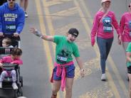 A young runner is seen dancing during the race