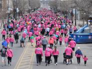 Hundreds of runners are shown from behind as they make their way through the race