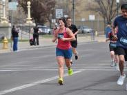 A female runner is shown running during the race