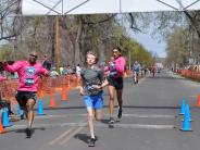 Several runners are shown crossing the finish line