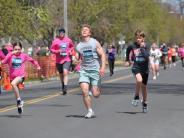 Many runners are shown running towards the finish line