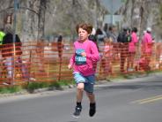 A small child is shown running towards the finish line