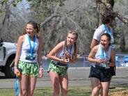 Several girls watch the race from the sidelines 