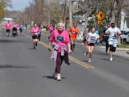 A few runners are shown making their way down the street, including an older runner 