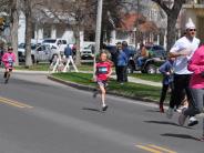 A small child runs down the street 
