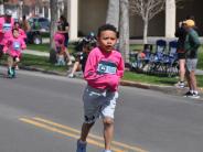 A young child is shown running down the street