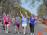 Several runners are shown walking to the finish line
