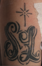 Initials SL tattoo on right forearm