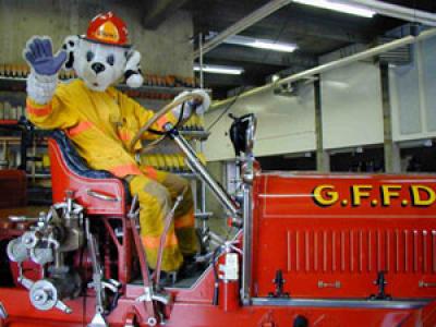 Sparky rides a fire engine photo