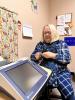 Another picture of Kathy Johnson, volunteer audiologist, with newly acquired hearing screening equipment